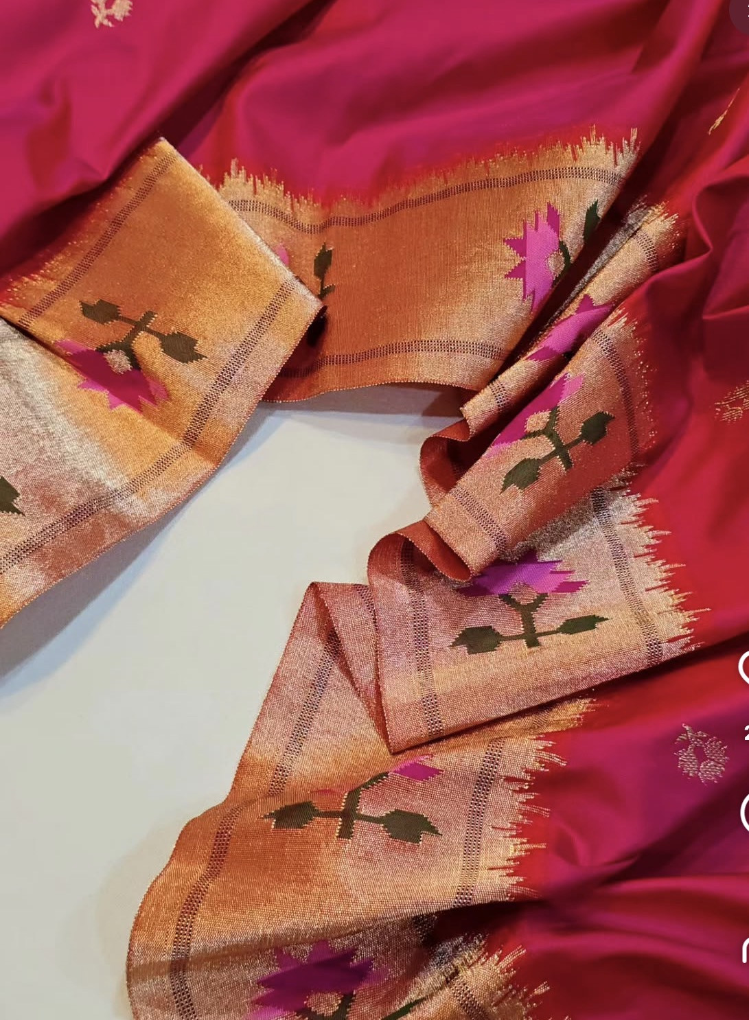 Rich pink fabric with metallic floral border identified by the founder as Paithani