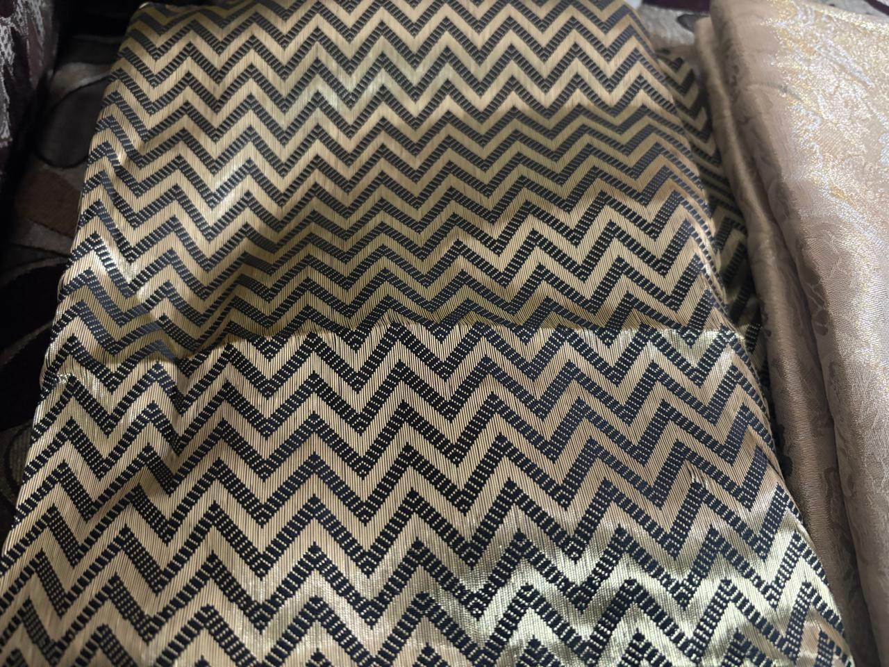Black-and-gold chevron fabric identified by the founder as semi-brocade